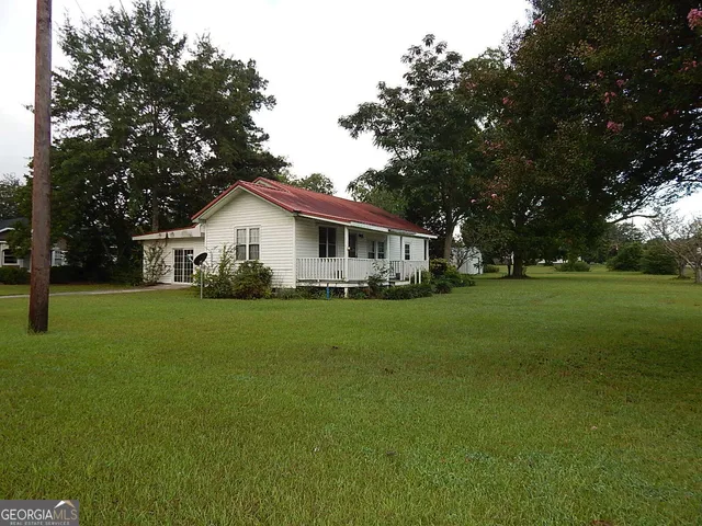 a front view of house with yard and green space