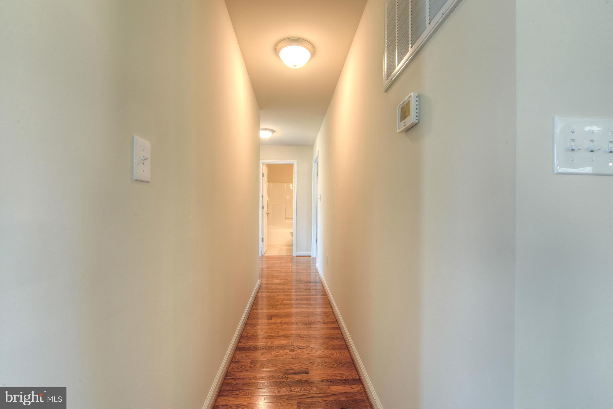 12163 Ridge Road King George, VA 22485 - Photo 21 of 30 HARDWOOD FLOORS IN HALL TO SLEEPING QUARTERS