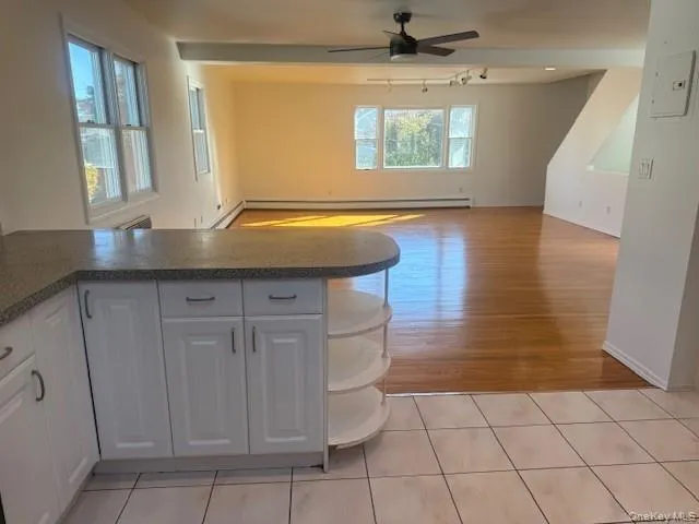 a view of a kitchen with a sink and wooden floor