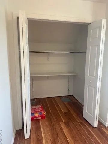 a room with wooden floor and furniture