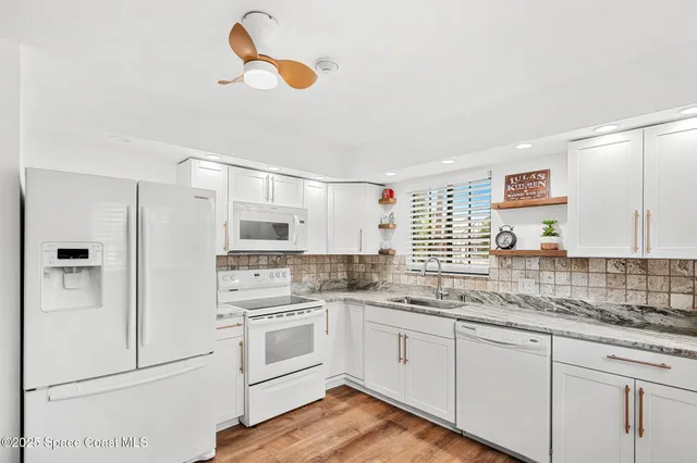 a kitchen with a white cabinets and white appliances