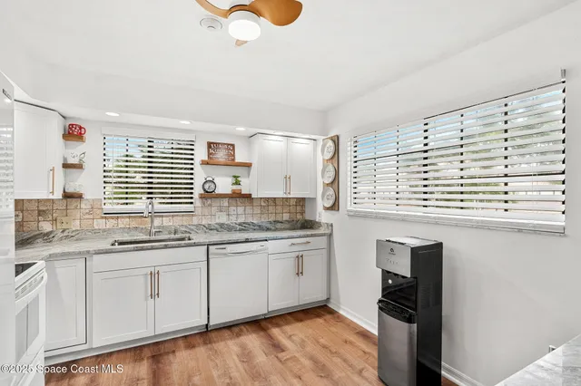 a kitchen with stainless steel appliances granite countertop a stove and a sink
