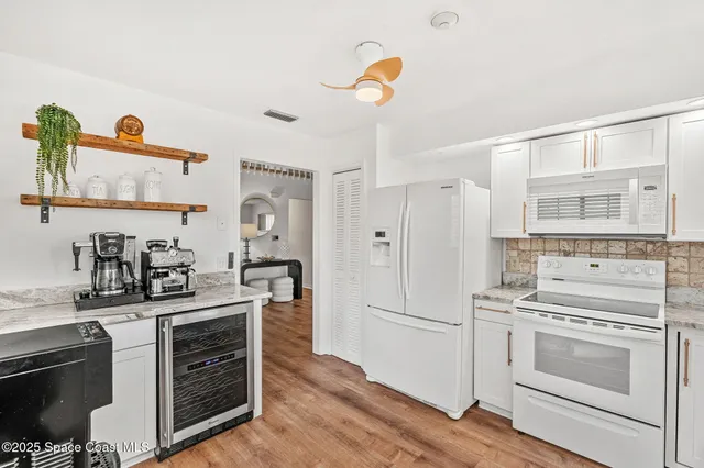 a kitchen with a refrigerator stove and sink
