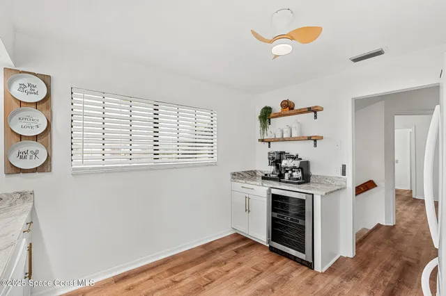 a kitchen with a stove and wooden floor