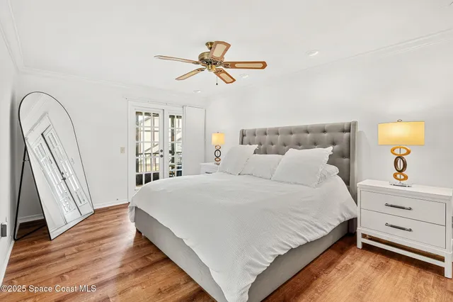 a bedroom with a bed and a mirror on the dresser