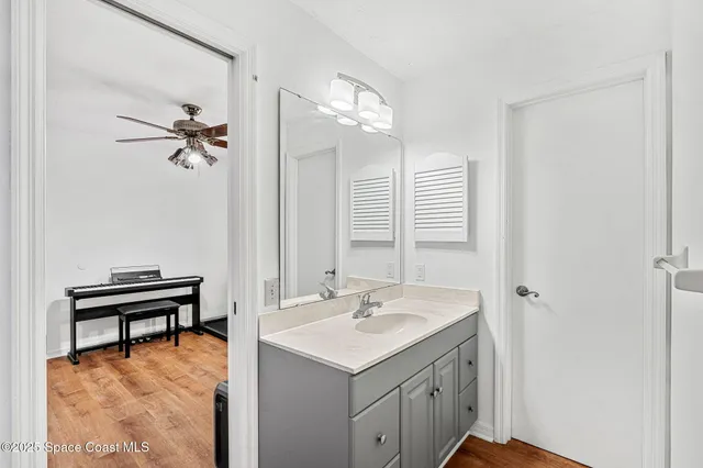 a bathroom with a sink vanity and a mirror