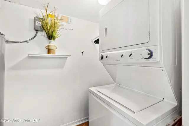 a view of a room with a ceiling fan