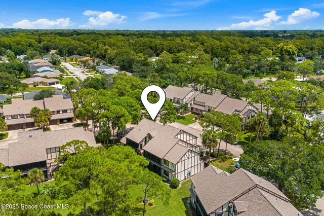 an aerial view of residential houses with outdoor space and street view