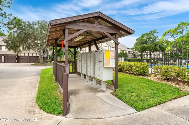 a aerial view of a house with a yard and lake view