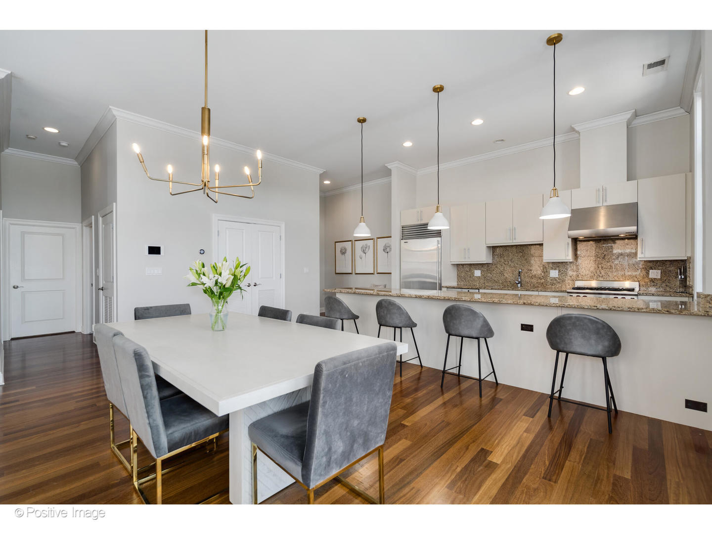 955 West Monroe Street, Unit 4A Chicago, IL 60607 - Photo 7 of 24 a open kitchen with stainless steel appliances kitchen island granite countertop a dining table chairs and white cabinets