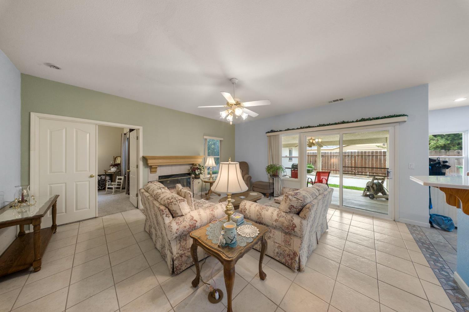 2101 Arabian Way Turlock, CA 95380 - Photo 11 of 38 a living room with furniture and a chandelier