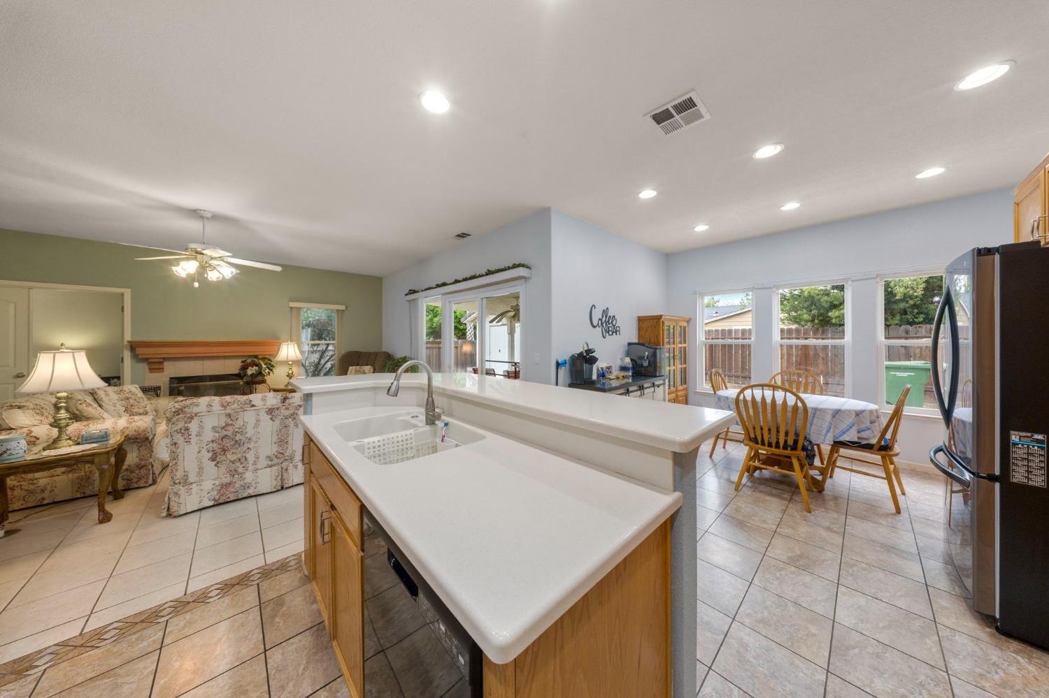 2101 Arabian Way Turlock, CA 95380 - Photo 19 of 38 a large living room with stainless steel appliances furniture a couch and a view of kitchen