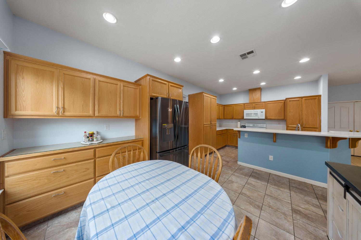2101 Arabian Way Turlock, CA 95380 - Photo 21 of 38 a kitchen with stainless steel appliances kitchen island granite countertop a sink and cabinets