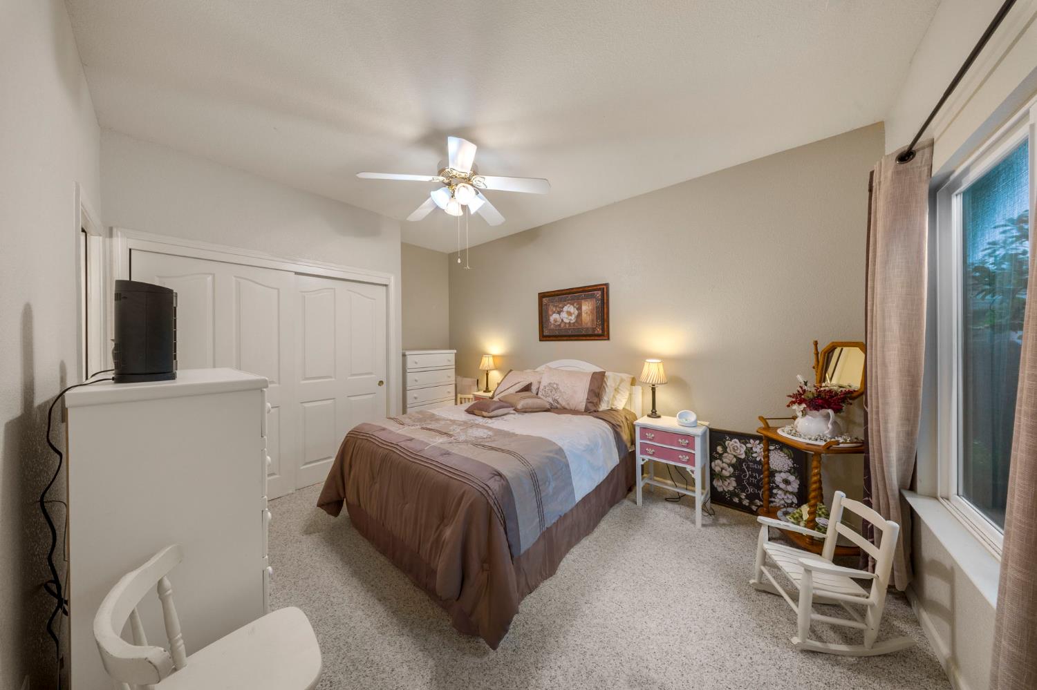 2101 Arabian Way Turlock, CA 95380 - Photo 22 of 38 a bedroom with a bed and a chandelier