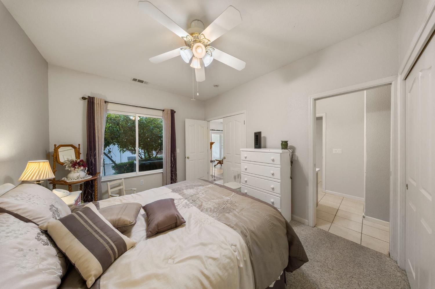 2101 Arabian Way Turlock, CA 95380 - Photo 23 of 38 a bedroom with a bed and a chandelier