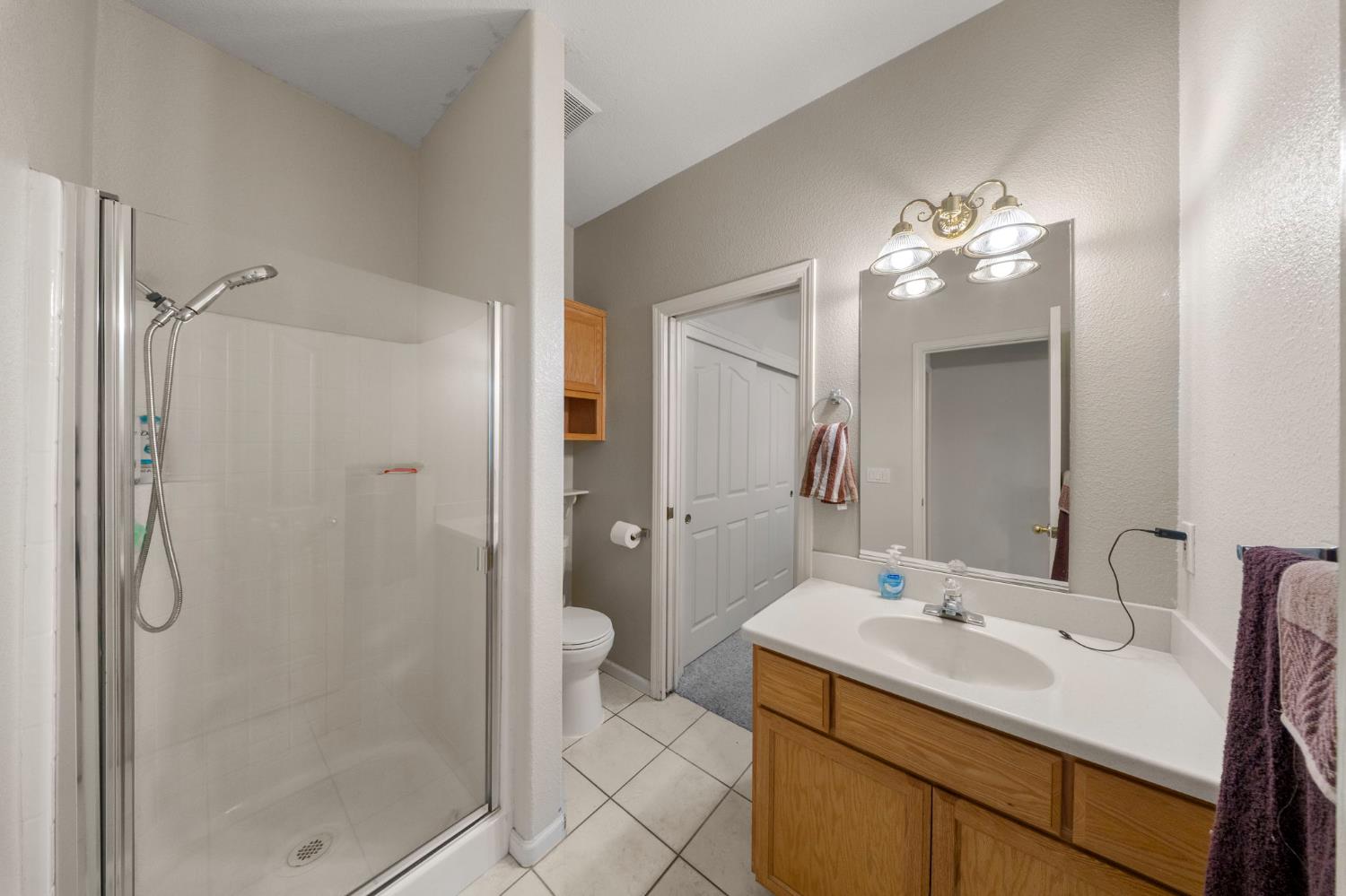 2101 Arabian Way Turlock, CA 95380 - Photo 24 of 38 a bathroom with a sink vanity granite shower and a mirror