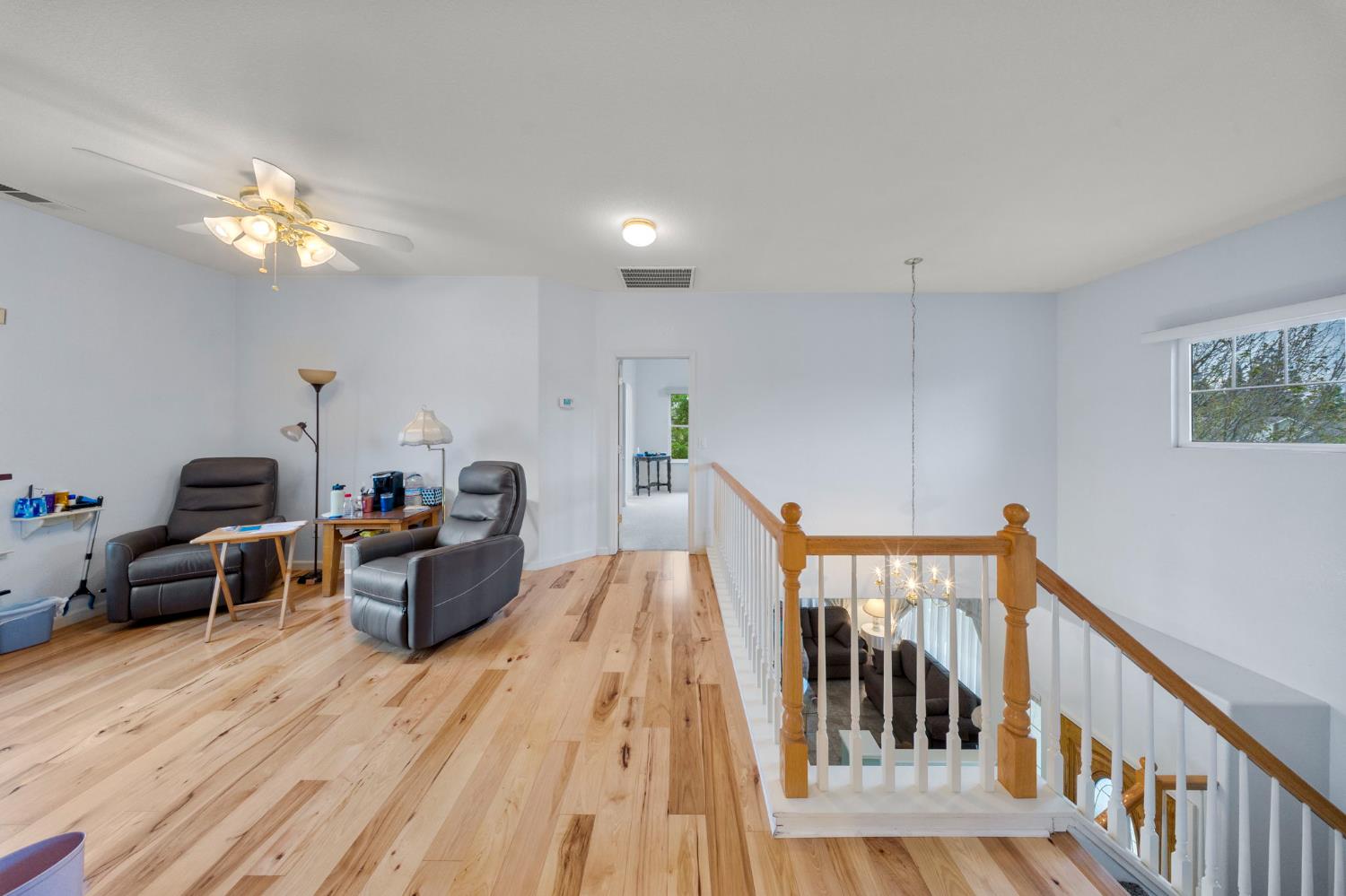2101 Arabian Way Turlock, CA 95380 - Photo 26 of 38 a view of a livingroom with furniture wooden floor windows and a chandelier
