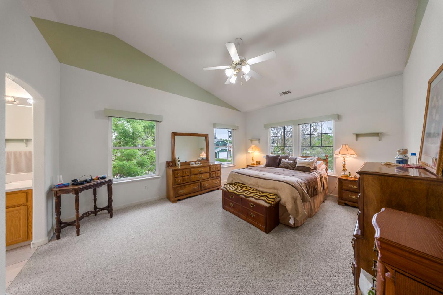 2101 Arabian Way Turlock, CA 95380 - Photo 31 of 38 a spacious bedroom with a bed and a chandelier