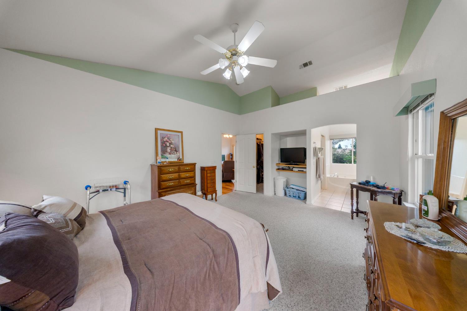 2101 Arabian Way Turlock, CA 95380 - Photo 32 of 38 a bedroom with a large bed and a chandelier