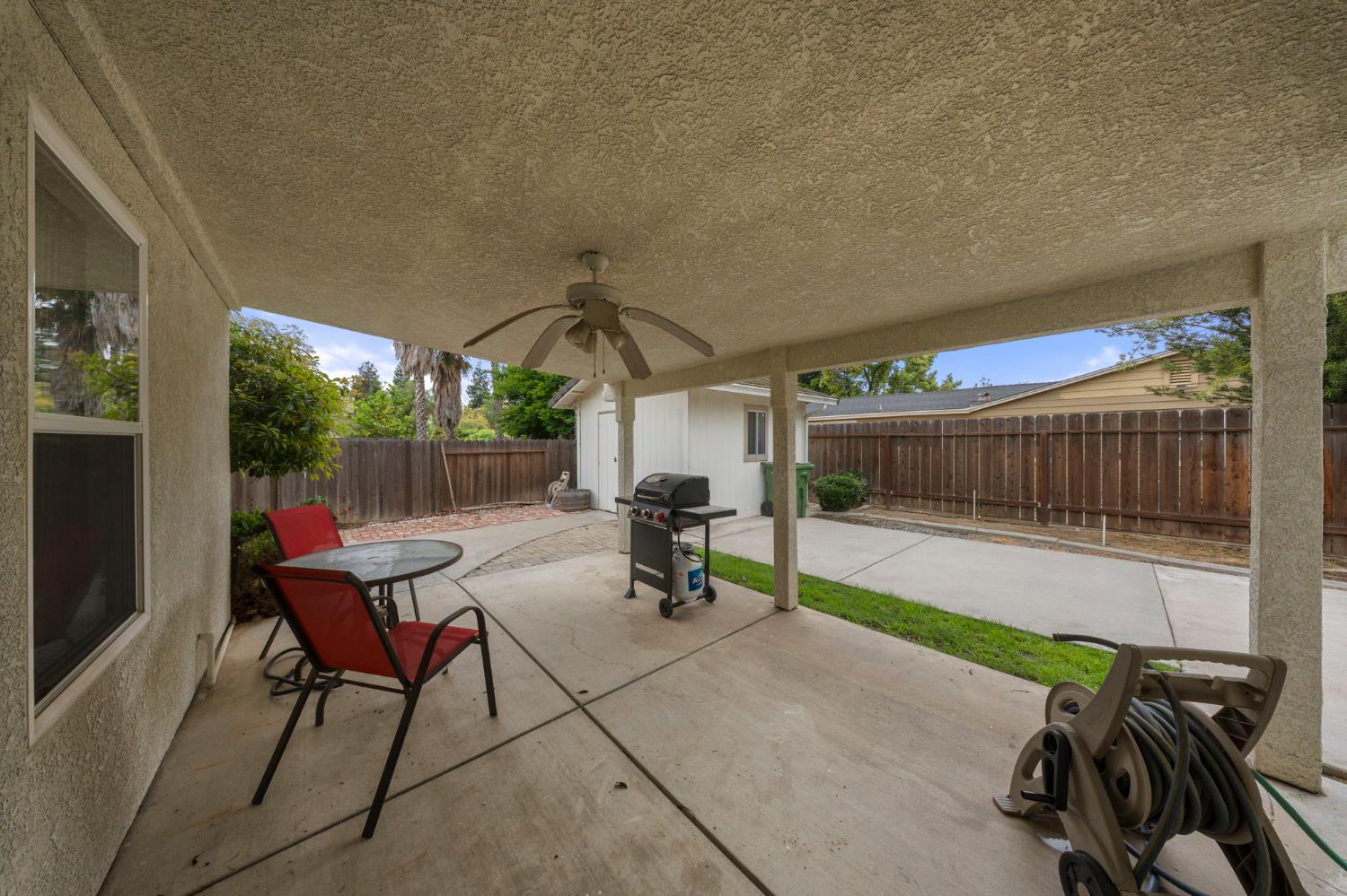 2101 Arabian Way Turlock, CA 95380 - Photo 34 of 38 a view of a patio with a table and chairs under an umbrella