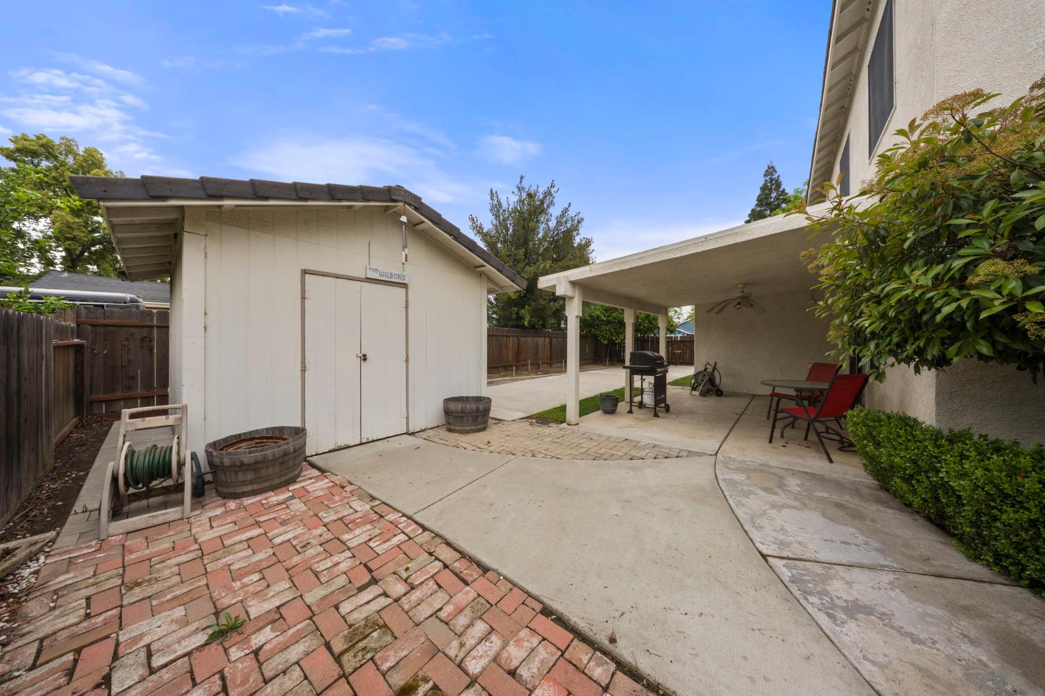 2101 Arabian Way Turlock, CA 95380 - Photo 35 of 38 a building exterior with furniture and potted plants