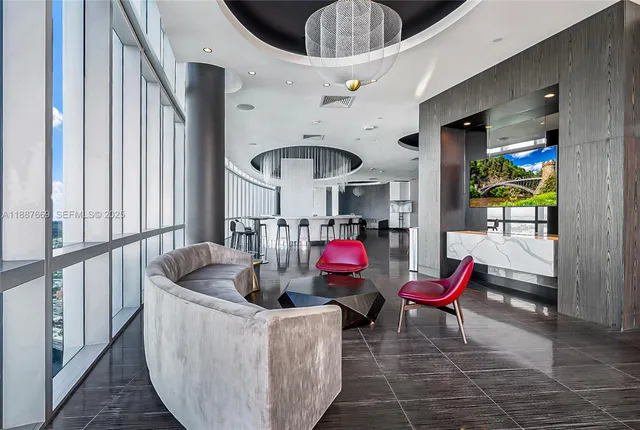 a living room with furniture and a floor to ceiling window