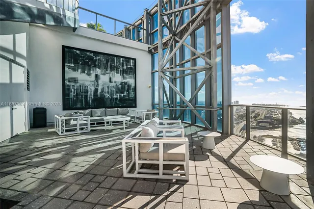 a view of balcony with chairs and iron fence