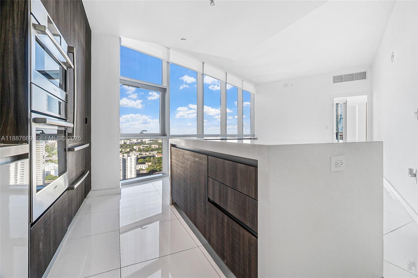 851 Northeast 1st Avenue, Unit 2802 Miami, FL 33132 - Photo 10 of 50 a kitchen with stainless steel appliances a refrigerator and a sink