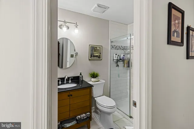 a bathroom with a toilet a sink and mirror