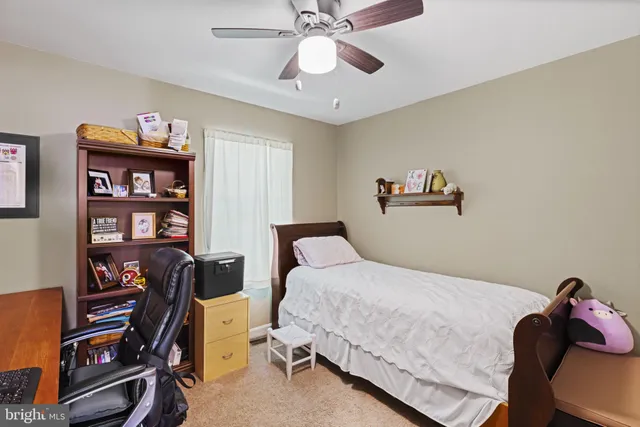 a bedroom with furniture and a book shelf