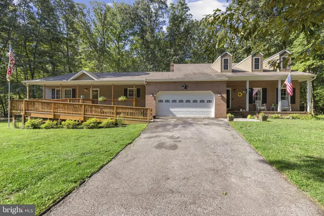 a front view of a house with a yard table and chairs
