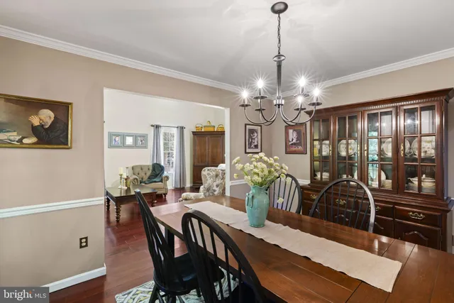 a view of a dining room with furniture wooden floor and chandelier