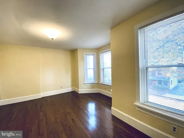 a view of wooden floor and windows in a room