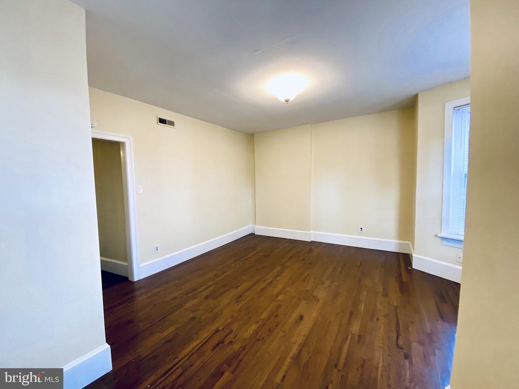 1415 North Harrison Street, Unit 2 Wilmington, DE 19806 - Photo 12 of 21 an empty room with wooden floor