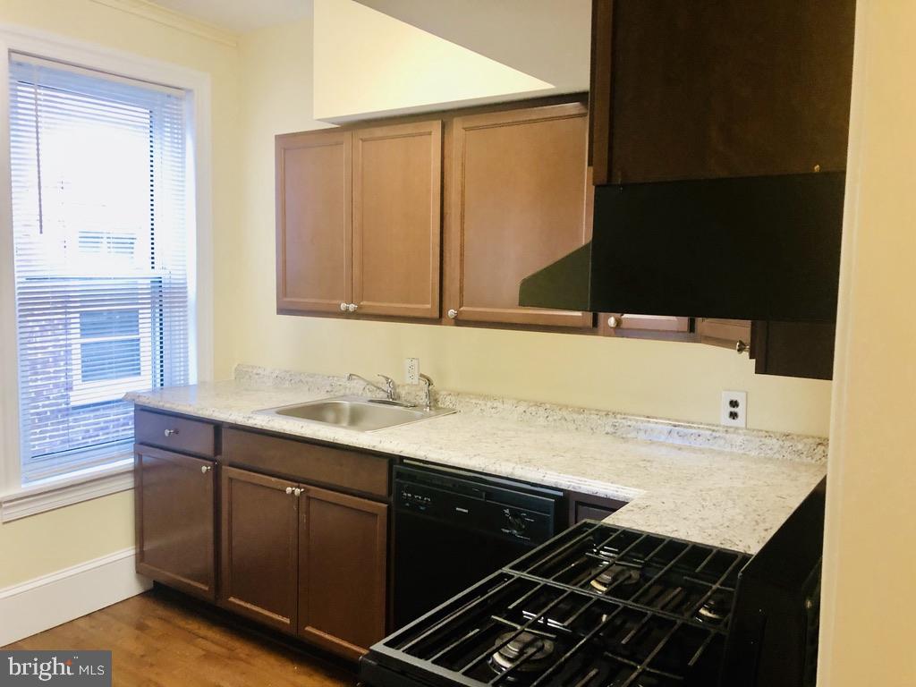 1415 North Harrison Street, Unit 2 Wilmington, DE 19806 - Photo 4 of 21 a kitchen with a sink and cabinets