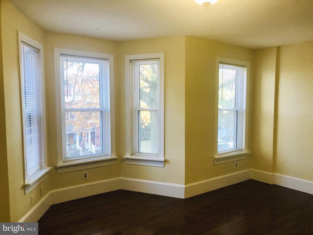 1415 North Harrison Street, Unit 2 Wilmington, DE 19806 - Photo 8 of 21 a view of an empty room with wooden floor and a window
