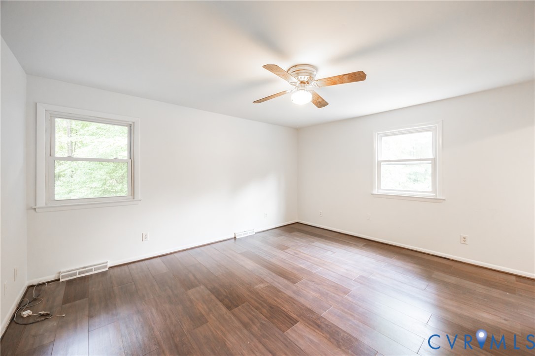 9016 Robin Road Disputanta, VA 23842 - Photo 13 of 30 Unfurnished room with wood finished floors, plenty