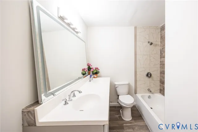 a bathroom with a toilet a sink and a bathtub