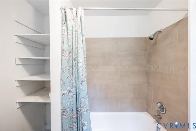 a bathroom with a bathtub and shower