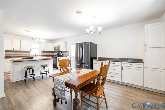 a view of kitchen with refrigerator dining table and chairs