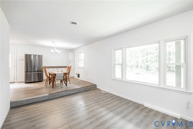 a dining room with furniture and wooden floor