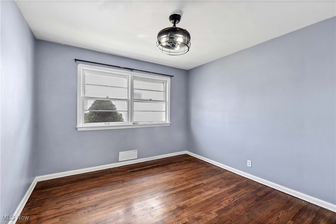 6506 Snow Road Parma, OH 44129 - Photo 13 of 25 Spare room featuring dark wood-style floors and baseboards