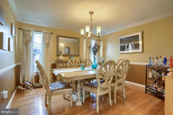 a view of a dining room with furniture wooden floor and chandelier