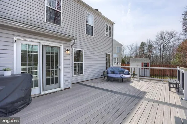 a view of a roof deck with wooden floor and fence