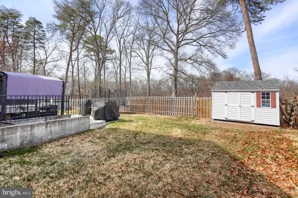 a view of a swimming pool with back yard of a house