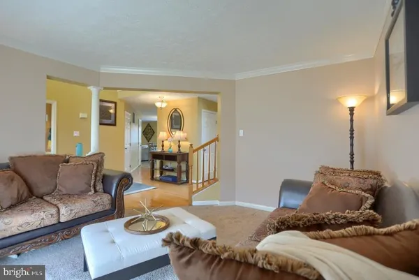 a living room with a couch and a lamp