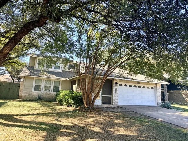 a view of a house with a tree in the background