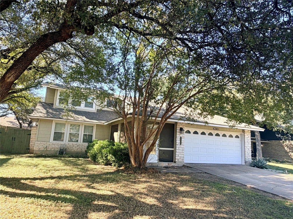 a view of a house with a tree in the background