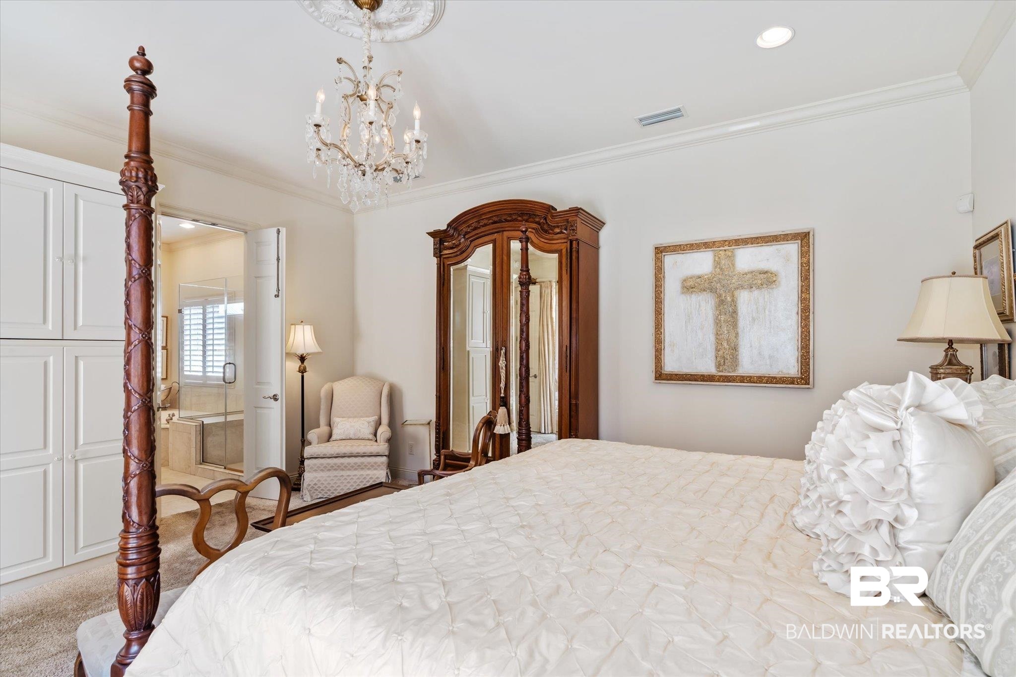 3963 Wimbledon Park Mobile, AL 36608 - Photo 22 of 51 Bedroom featuring light colored carpet, connected bathroom, an inviting chandelier, and ornamental molding
