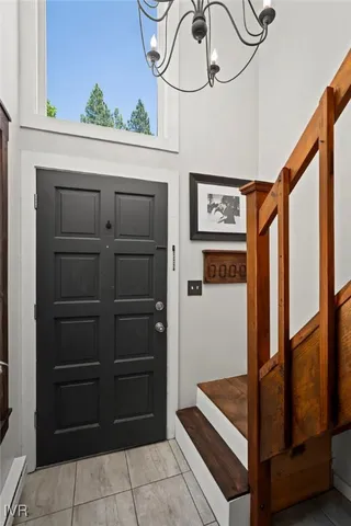 a living room with furniture a couch and large windows